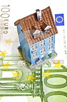 House with money - mortgaging concept
