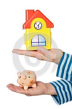 House and moneybox in hands photo