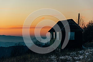 House in mountains with sunset