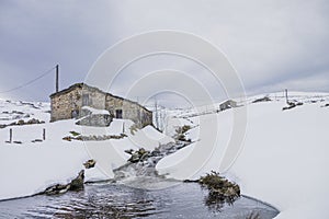 House near a snowy river