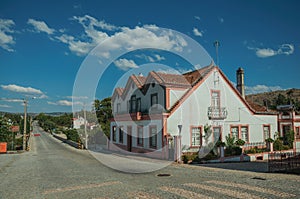 House next to a road passing through countryside