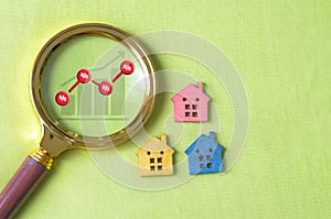 A house next to an unstable graph symbolizes the volatility and unpredictability in the property market photo