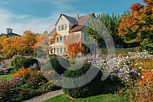 House with nice garden in fall. Flowers in the City Park of Bietigheim-Bissingen, Baden-Wuerttemberg, Germany, Europe