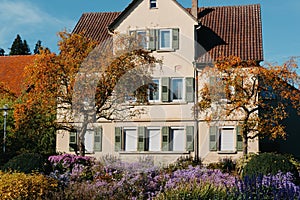 House with nice garden in fall. Flowers in the City Park of Bietigheim-Bissingen, Baden-Wuerttemberg, Germany, Europe