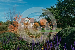 House with nice garden in fall. Flowers in the City Park of Bietigheim-Bissingen, Baden-Wuerttemberg, Germany, Europe