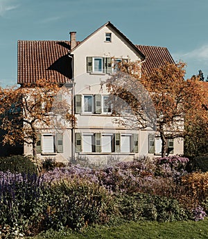 House with nice garden in fall. Flowers in the City Park of Bietigheim-Bissingen, Baden-Wuerttemberg, Germany, Europe