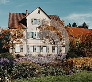 House with nice garden in fall. Flowers in the City Park of Bietigheim-Bissingen, Baden-Wuerttemberg, Germany, Europe