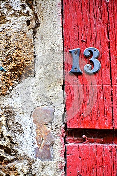 House number 13 on antique rustic wall, old, rusty metal numbers