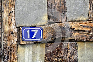 House number 17 on antique rustic wall, old, rusty enamel sign