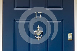 House number 17 in silver on blue