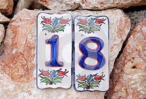 House number 18 on the stone wall