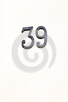 House number 39 slanted on a white wall