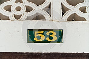 House number 53, yellow. Plate with a frame on self-tapping screws