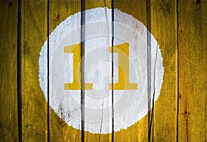 House number or calendar date in white circle on yellow toned