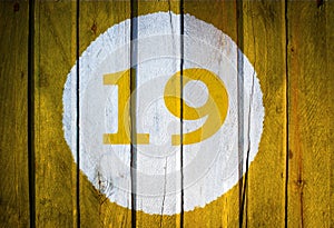 House number or calendar date in white circle on yellow toned