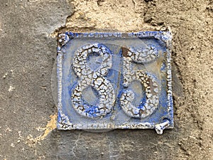 85 house number plate on wall