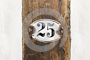 house number twenty-five 25 plaque on wall