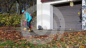 House owner woman cleaning entrance to her car garage in autumn