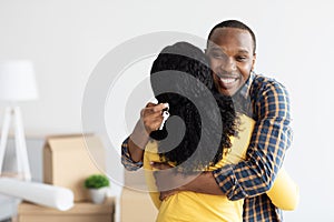 House Owners. Happy African American Man Holding Home Keys And Embracing Wife