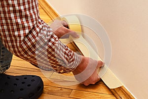 House Painter glues masking tape