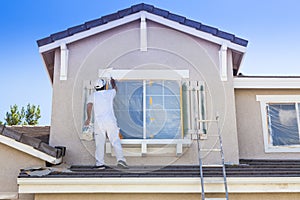 House Painter Painting the Trim And Shutters of Home