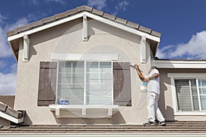 House Painter Painting the Trim And Shutters of Home photo