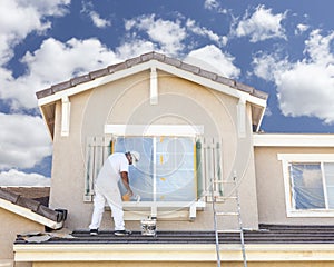 House Painter Painting the Trim And Shutters of Home