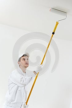 House painter at work with painting roller photo