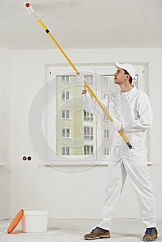 House painter at work with painting roller