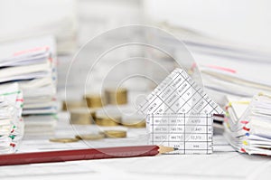 House and pencil with blur coins between overload of paperwork