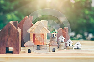 The house placed on a coin is like a village or condo. planning savings money of coins to buy a home