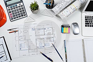 House plan blueprint paper with laptop pencil calculator on architecture office desk