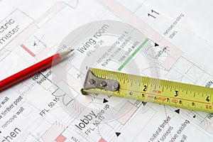 House plans with pencil and tape measure