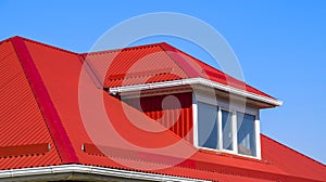 House with plastic windows and a red roof of corrugated sheet