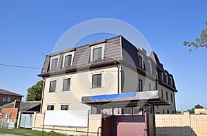 The house with plastic windows and a roof of corrugated sheet