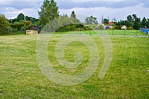 A house plot with well maintained grass and compost box in the corner