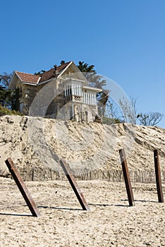 House with poles erosion at Beach