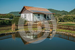 House and pond amid rural landscape