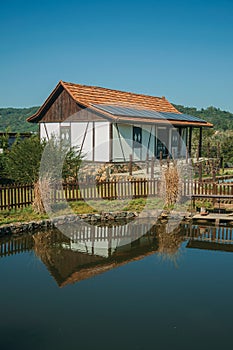 House and pond amid rural landscape photo