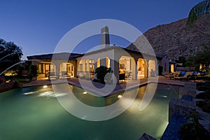 House With Pool In Backyard At Dusk