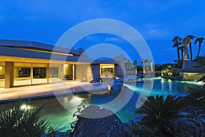 House With Pool In Backyard At Dusk