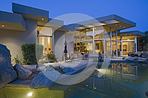 House With Pool In Backyard At Dusk