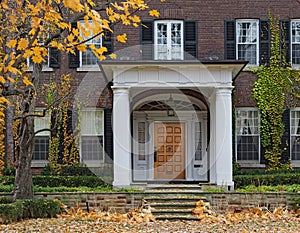 House with portico entrance and vines
