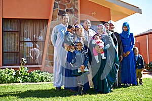 House, portrait and family of muslim people, outside and home for happy Eid celebration. Garden, lawn and islamic woman