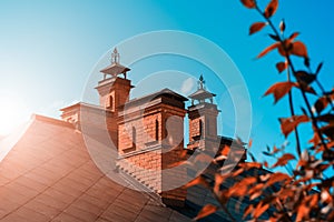 The house is of red brick with a copper roof