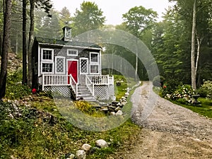 House with a Red Door on a Dirt Road