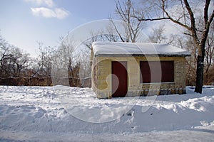 A house with red door in snow field