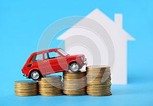 House, red miniature car and money