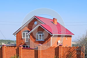 house with a red roof and red brick. Red brick . Roof of metal