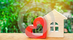 House with a red wooden heart. House of lovers. Affordable housing for young families. Valentine`s day house. photo